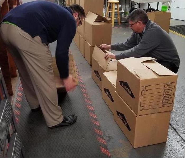 SERVPRO employees loading boxes of toys