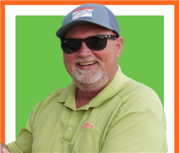SERVPRO employee RJ Barnett, male with hat on and posing outside